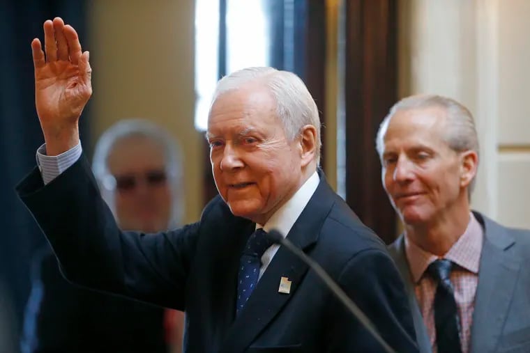 FILE - In this Feb. 21, 2018, file photo, Sen. Orrin Hatch (R., Utah) waves after addressing the Utah Senate while Senate President Wayne Niederhauser (R., Sandy) looks on at the Utah State Capitol, in Salt Lake City.  Hatch is ending his tenure as the longest-serving Republican senator in history, Thursday, Jan. 3, 2019, capping a unique career that positioned him as one of the most prominent conservative voices in the United States.
