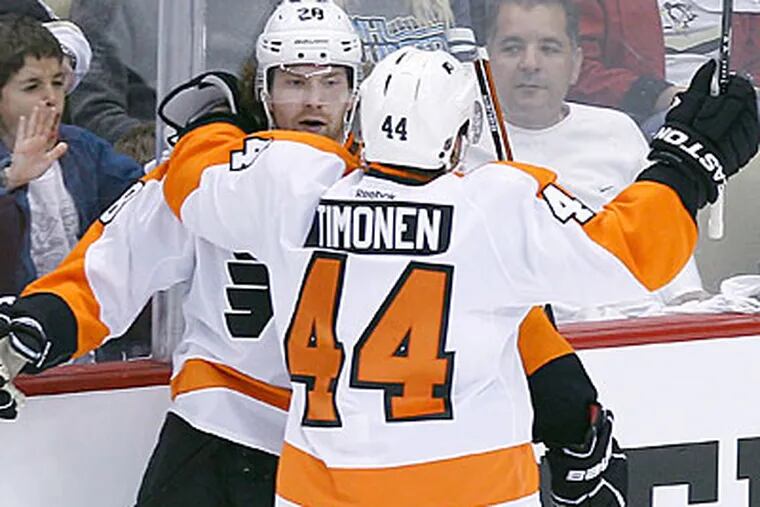 Claude Giroux and Kimmo Timonen celebrate after Giroux's second period short-handed goal. (Yong Kim/Staff Photographer)
