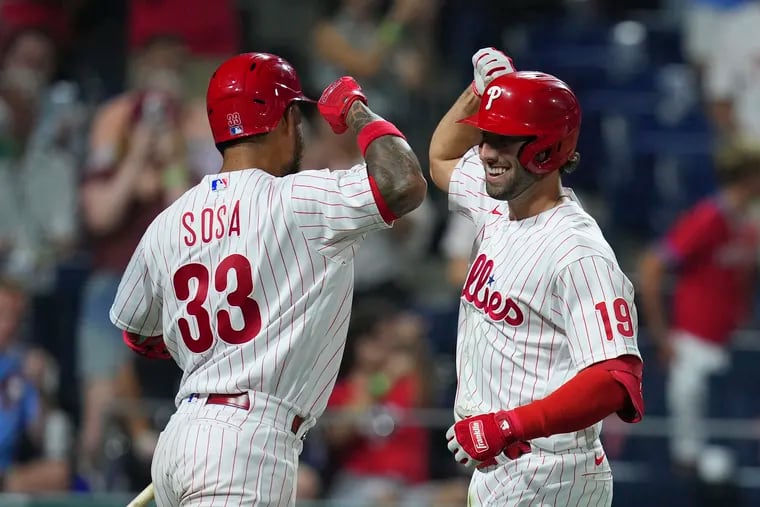 Matt Vierling celebrates with Edmundo Sosa after hitting a solo home run in the bottom of the seventh inning against the Cincinnati Reds at Citizens Bank Park on August 23, 2022 in Philadelphia, Pennsylvania. The Philadelphia Phillies defeated the Cincinnati Reds 7-6. (Photo by Mitchell Leff/Getty Images)