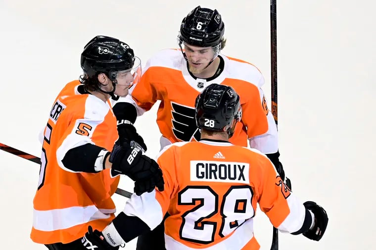Claude Giroux (28) celebrating his goal with teammates Philippe Myers (5) and Travis Sanheim (6) during the second period Tuesday.