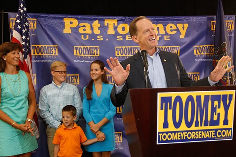 Sen. Pat Toomey, right, acknowledges the crowd gathered for his official launch for re-election in King of Prussia on Sunday, Sept. 13, 2015. His family, left to right, wife Kris Toomey; son Patrick Toomey, 14; daughter Bridget Toomey, 15;  and son Duncan Toomey, 5; stand with him on the podium. ( Michael Bryant / Staff Photographer )