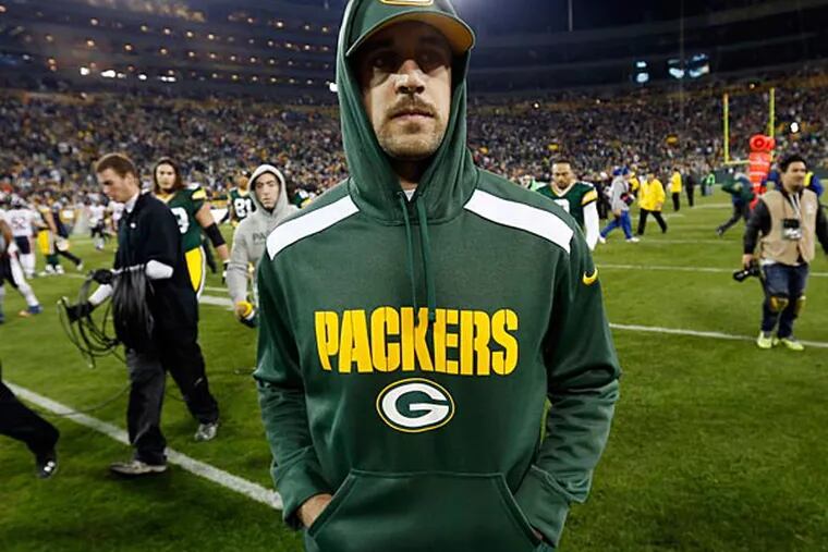 Green Bay Packers' Aaron Rodgers walks off the field after an NFL football game against the Chicago Bears Monday, Nov. 4, 2013, in Green Bay, Wis. Rodgers was injured in the first half of the game. The Bears won 27-20. (AP Photo/Mike Roemer)