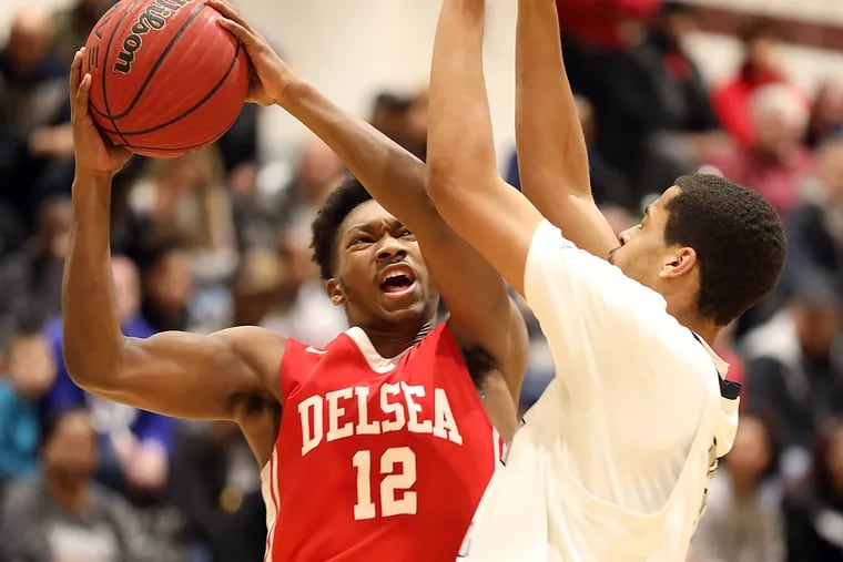 Game Story off Delsia Hi at Timber Creek Boy's Basketball Game--  Delsea HS #12 Javon Gordon is about score against Timber Creek HS #32 David Cade during 2nd Period. Delsea HS won 80 to 70 over Timber Creek HS.  AKIRA SUWA / For The Inquirer. 