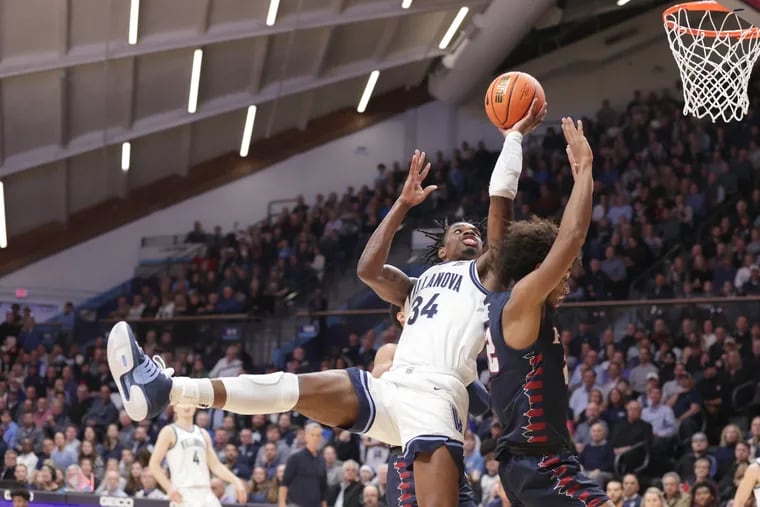 Brandon Slater (left) of Villanova gets fouled by Lucas Monroe of Penn as he goes up for a shot during the 1st half of a Big 5 game on Dec. 7, 2022 at the Finneran Pavilion at Villanova University.