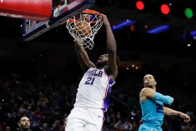 Sixers center Joel Embiid dunking against Charlotte during the second quarter Sunday.