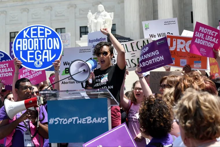Pro-choice activists hold placards during a rally at the Supreme Court in reaction to the passage of bills in Alabama, Georgia, Missouri, and other states that restrict access to abortion on May 21, 2019, in Washington, D.C.
