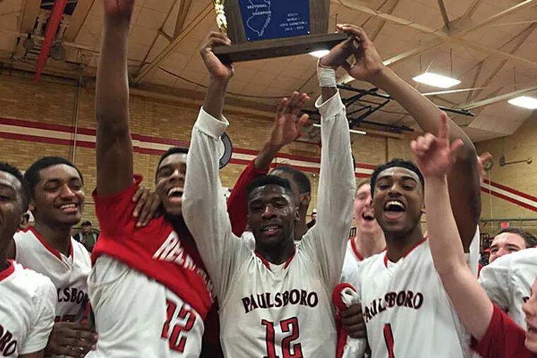 Theo Holloway and his Paulsboro teammates celebrate winning the South Jersey Group 1 title. (Phil Anastasia/Staff)
