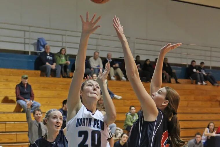 North Penn's #20, Lauren Crisler, center, shoots over Central Bucks East's Courtney Webster, right, in the first quarter. Central Bucks East plays at North Penn in girls' basketball, 7 p.m.  SNPENN22 12/21/2012 ( MICHAEL BRYANT / Staff Photograher )