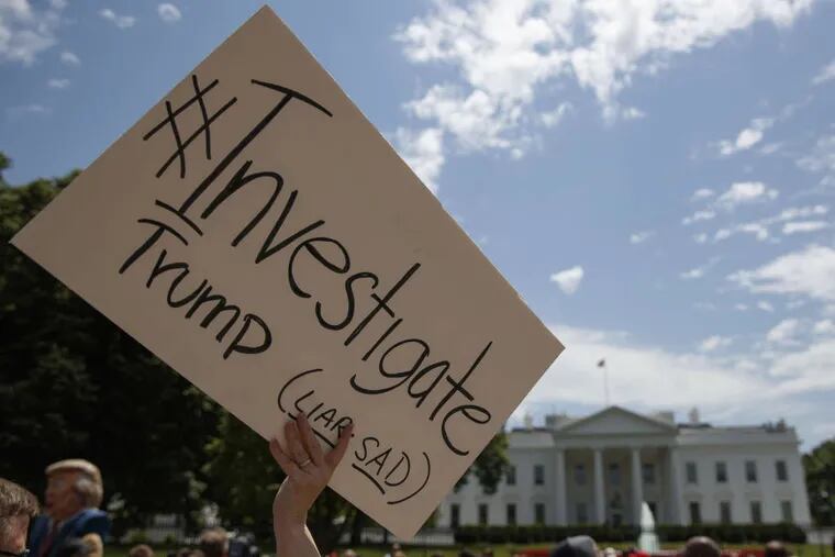 Demonstrators gather outside the White House on Wednesday, a day after President Donald Trump fired FBI Director James Comey.