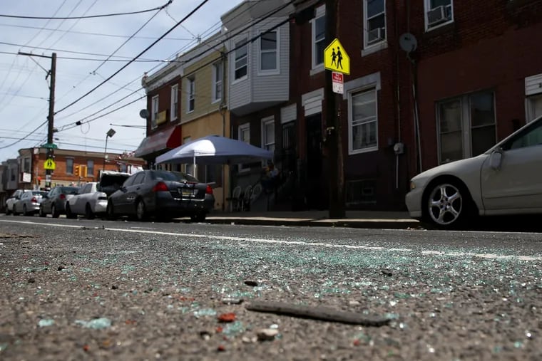 Broken glass remains at the scene of a police shooting on the 3400 block of G Street in North Philadelphia on Tuesday, May 21, 2019. An officer in an unmarked police car allegedly shot an unarmed man who was panhandling Monday night.