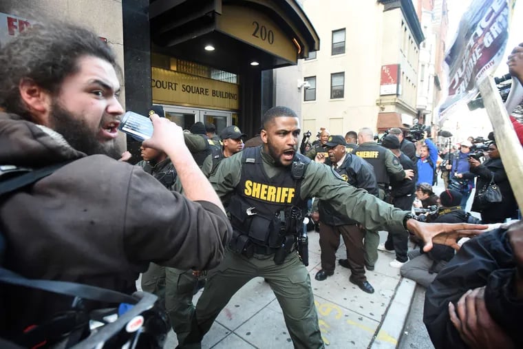 Baltimore sheriff's deputies try to secure the courthouse area after the judge declared a mistrial.