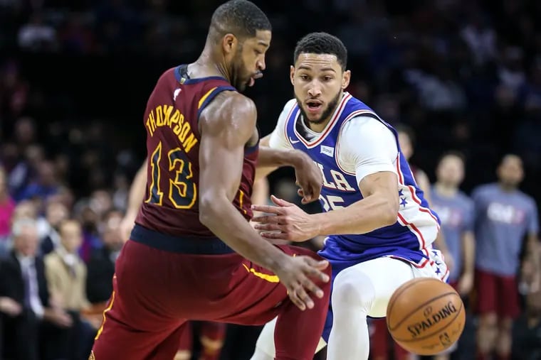 The Sixers' Ben Simmons (right) watching a loose ball with the Cavaliers'  Tristan Thompson on Tuesday.