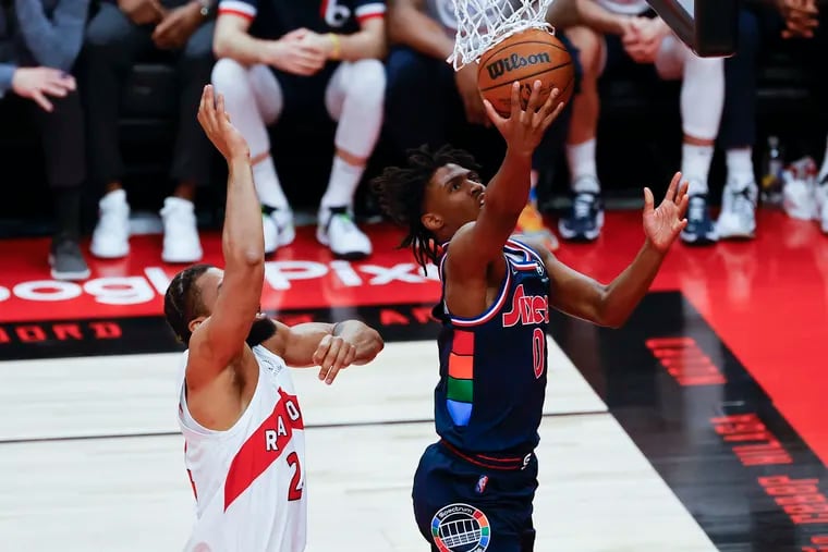 Sixers guard Tyrese Maxey lays-up the basketball past Toronto Raptors center Khem Birch in the second quarter during game three of the first-round Eastern Conference playoffs on Wednesday, April 20, 2022 in Toronto.