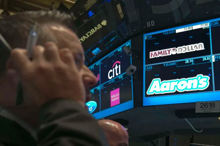 A trader works at the post that handles Family Dollar on the floor of the New York Stock Exchange.