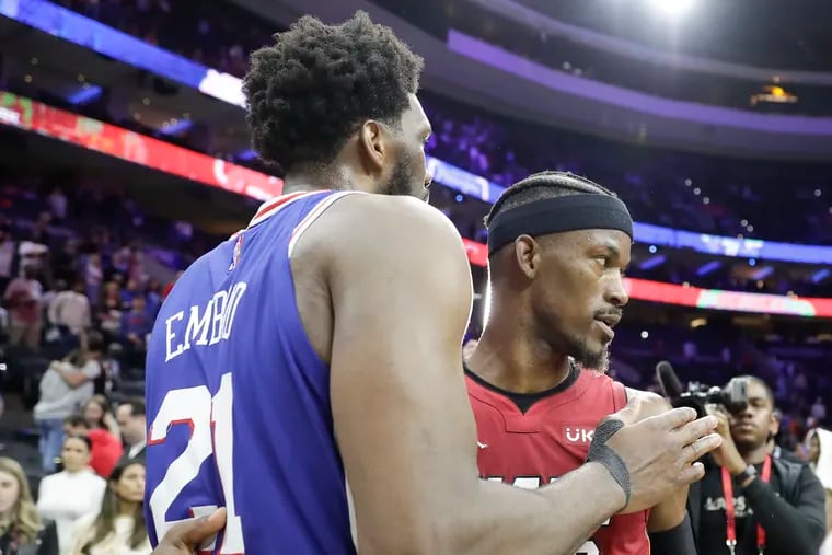 Sixers center Joel Embiid meets with Heat forward Jimmy Butler after Sixers lost their Eastern Conference semifinal series to Miami.