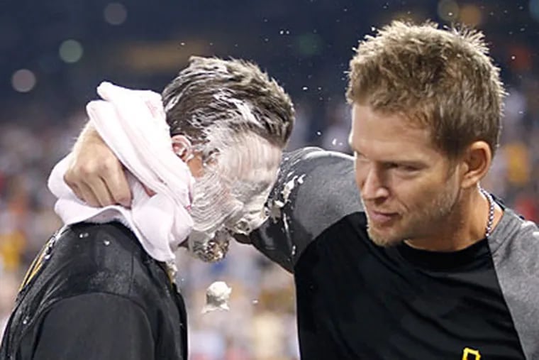 The Pirates' Drew Sutton, left, gets shaving cream in the face after hitting the winning home run in Tuesday's game. (Keith Srakocic/AP)
