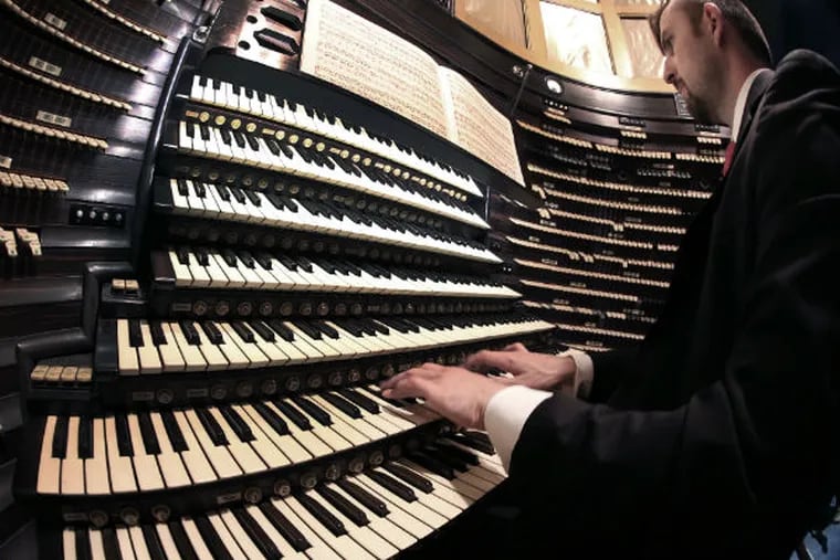 Steven Ball plays the Boardwalk Hall organ, the largest pipe organ in the world. "It was designed to be a library of all sound," he says. (TOM BRIGLIA/For The Inquirer)