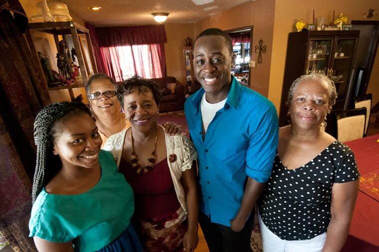 At their Cherry Hill, NJ home on Sept. 1, 2013, Thomas Hundley, whose family is trying to raise money for his last year of college. Here, from left to right: Hundley's sister, Patrice Hundley, 20; Debra Chatman, who used to be his babysitter; his mother Patricia Hundley; Thomas Hundley; and his godmother, Susan Simmons. ( APRIL SAUL / Staff )