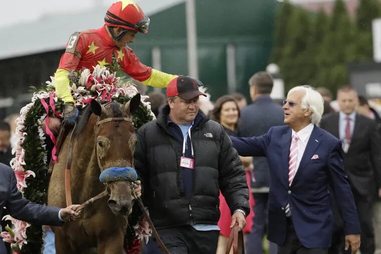 Trainer Bob Baffert (right) with horse Abel Tasman after victory in the Kentucky Oaks in May.