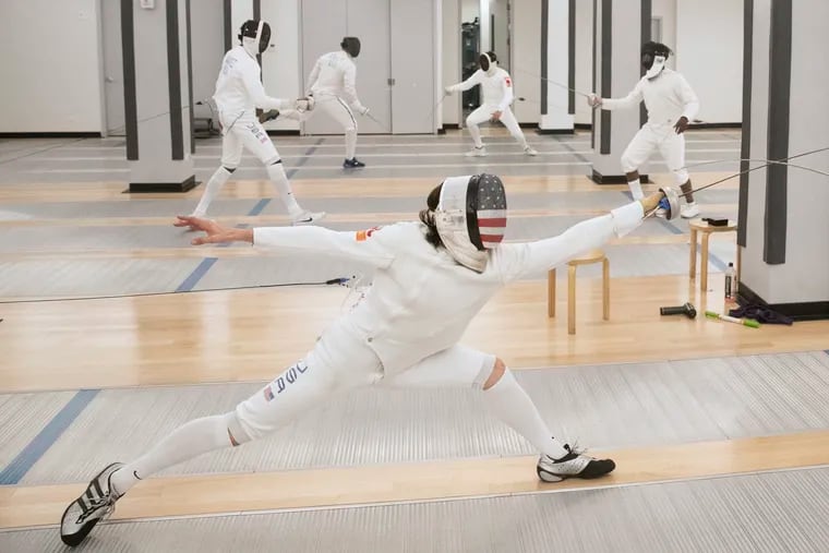 Jake Hoyle (center) bouts with teammate Adam Rodney (not pictured) at the Fencers Club in New York. Hoyle, a Wallingford native and former NCAA fencing champion who attended Columbia University, will compete in the Tokyo Olympics.