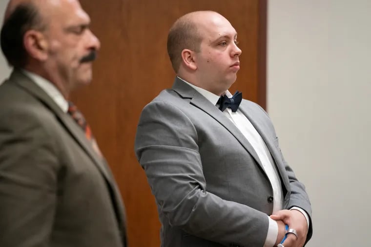 Suspended Gloucester Township Police Officer John Flinn, 29, right, stands with his attorney Louis Barbone, left, during closing arguments Tuesday in Flinn's trial on charges of official misconduct and endangering the welfare of a child.