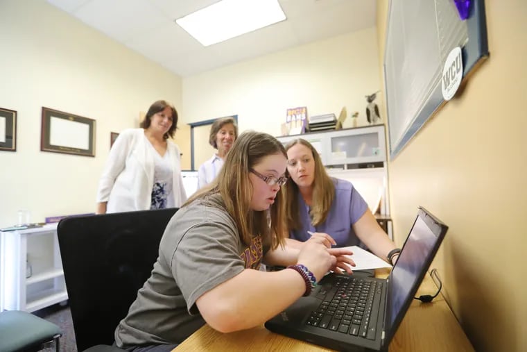 Emily Scott, meets with her adviser, Courtney Lloyd, and professors Monica Lepore, co-director of the program and Claire Verden at West Chester University. She's one of two students with intellectual disabilities, who will be enrolled at West Chester full-time for the first time this fall.