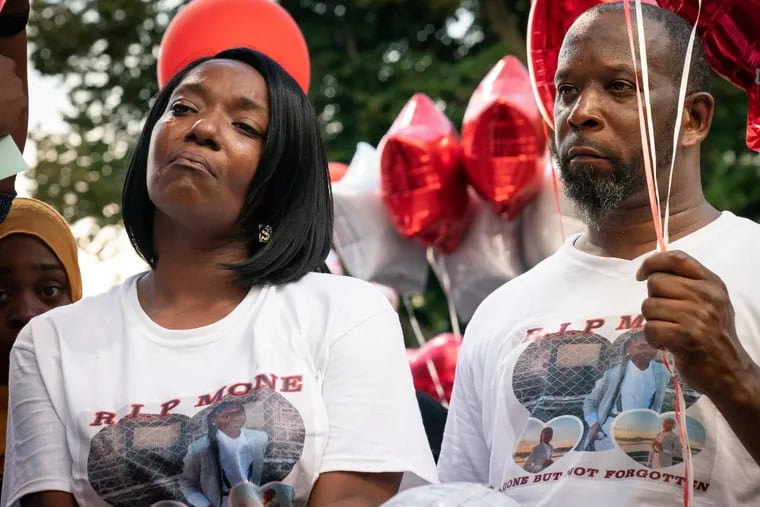 Lendale Rogers (left), Simone-Monea Rogers' mother, stands at a balloon release for her daughter at the Jerome Brown playground in North Philadelphia about a week after she was killed there while playing basketball. Simone-Monea's father is at right.