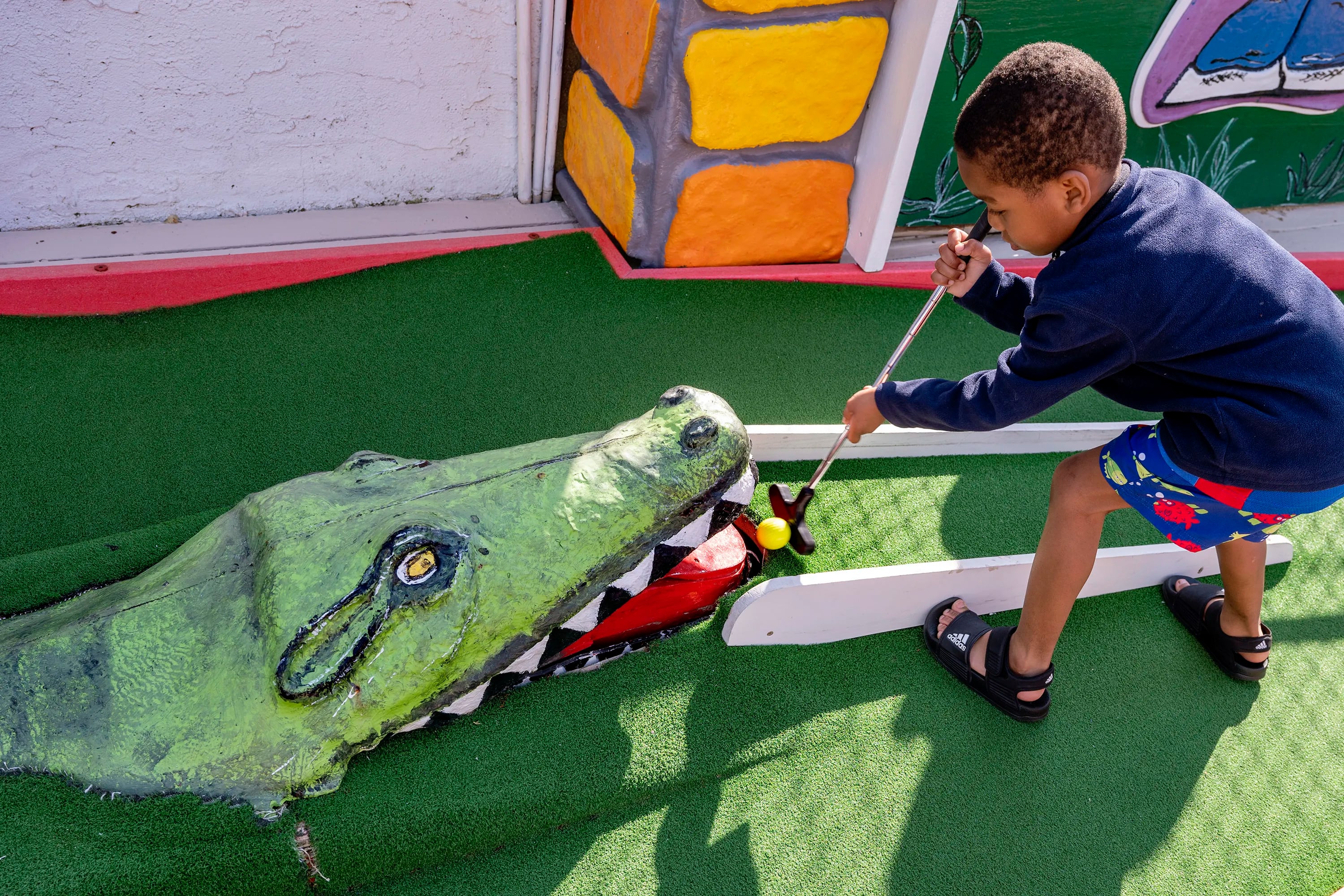 Justice, 5, takes on the alligator hazard at Tee Time Mini Golf in Ocean City. He was there with older brother and their mother.
