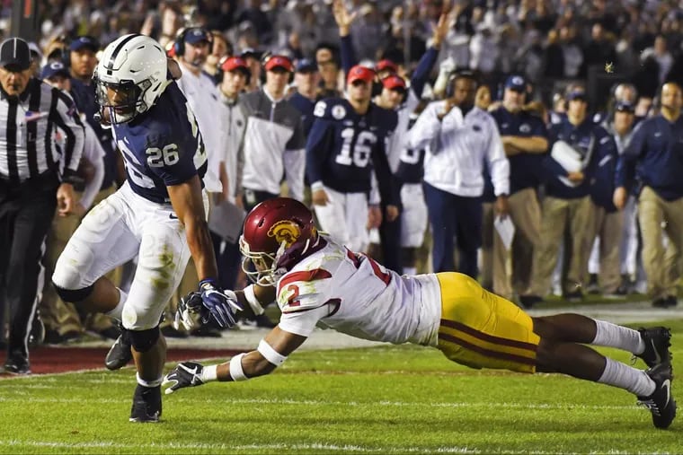 Penn State running back Saquon Barkley, left, scores past Southern California defensive back Adoree' Jackson during the second half of the Rose Bowl NCAA college football game Monday, Jan. 2, 2017, in Pasadena, Calif. (AP Photo/Mark J. Terrill)