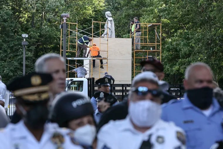 Police keep protesters away as the city places a box around the Christopher Columbus statue in South Philadelphia's Marconi Plaza in 2020.