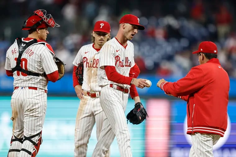 Phillies pitcher Connor Brogdon hands manager Rob Thomson the ball after pitching to the Reds and giving up a grand slam during the 10th inning at Citizens Bank Park on April 1.