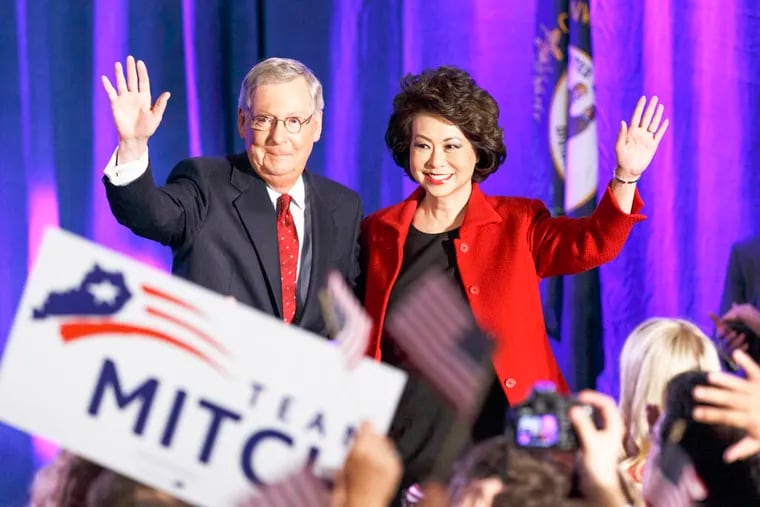 Senate Minority Leader Mitch McConnell of Kentucky, joined by his wife, former Labor Secretary Elaine Chao, celebrates with his supporters at an election night party in Louisville, Ky., on Tuesday, Nov. 4, 2014. (AP Photo/J. Scott Applewhite)
