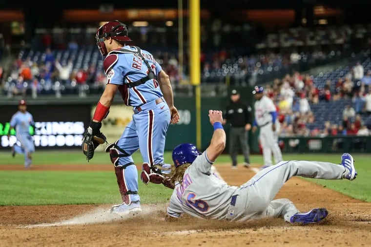 Phillies catcher J.T. Realmuto had no play on the Mets' Travis Jankowski, who scored a run during an 8-7 New York win on May 5.