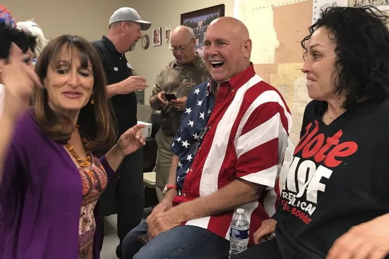 FILE – In this June 12, 2018, file photo, Nevada brothel owner Dennis Hof, second from right, celebrates with Heidi Fleiss, right, and others after winning the primary election in Pahrump, Nev.