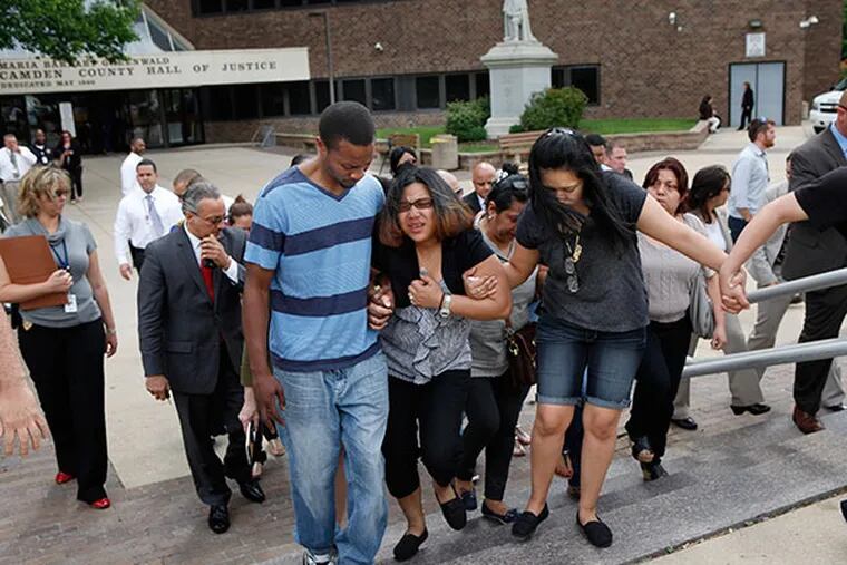 The mother of Fatima Perez (center), family and friends leave the Camden Courthouse after the arraignment. Carlos Alicea-Antonetti, 36, of Camden, and Ramon Ortiz, 57, of Pennsauken, are both accused of murdering 41-year-old Fatima Perez.( MICHAEL S. WIRTZ / Staff Photographer )