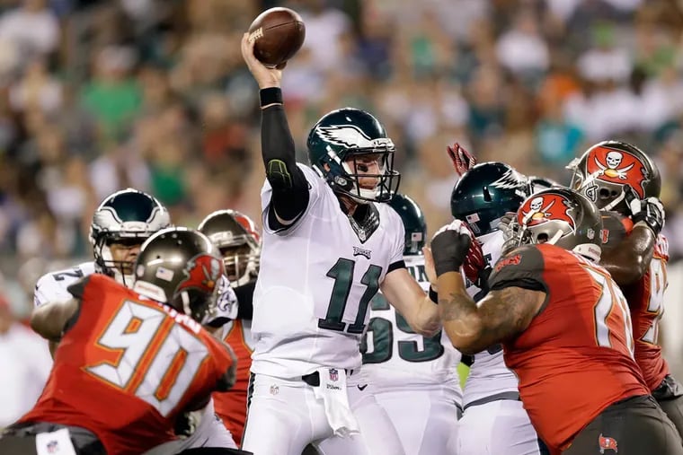 The Eagles' Carson Wentz throws the football against the Tampa Bay Buccaneers during the third quarter in a preseason game Thursday, Aug. 11, in Philadelphia. Wentz threw an interception on the play.