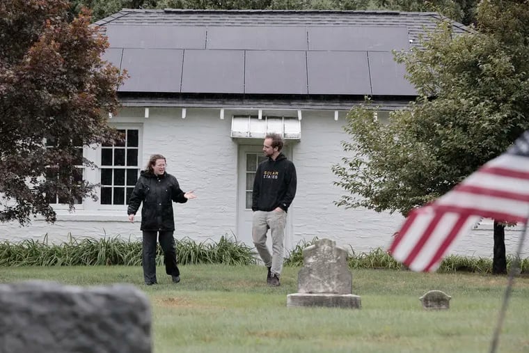 St. Paul’s Lutheran Church Green Team chair Joy Baxter (left) and Solar States solar and battery designer Jackson Kusiak at St. Paul’s cemetery maintenance building in Ardmore.