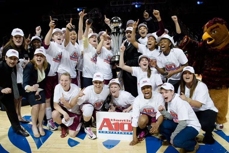 The Saint Joseph's women's basketball team poses with their trophy after defeating Fordham 47-46 in an NCAA college basketball game for the Atlantic 10 Conference tournament title, Saturday, March 16, 2013, in New York. (John Minchillo/AP)