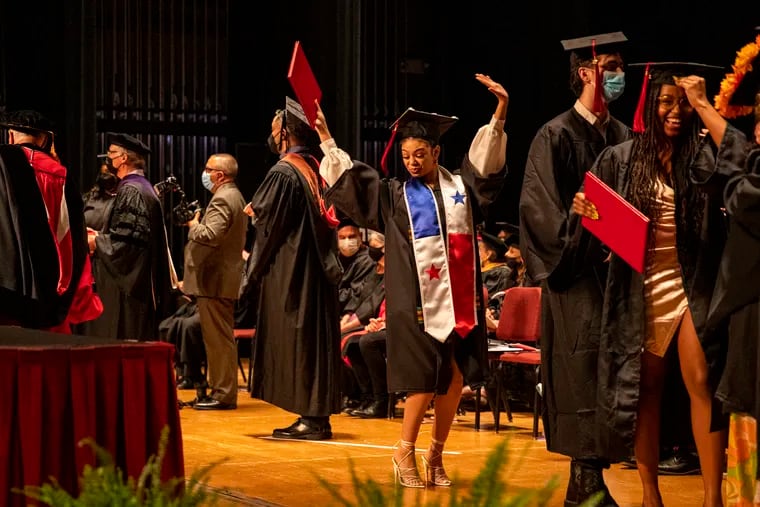 A student celebrates on stage after receiving their diploma for the University of the Arts 2022 graduation ceremony at the Academy of Music in Philadelphia, Pa., on Thursday, May 19, 2022.