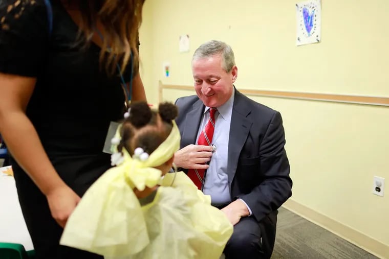 Jim Kenney, the Democratic nominee, play-acts with Laila Williams and her stethoscope at Spring Garden Academy. (DAVID SWANSON/Staff Photographer)