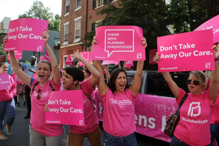 Planned Parenthood supporters (from left) Anneliese Van Arsdale, Lindsey Houster, Dana Sinopoli, and Betsy Jenson rally in the middle of Locust Street, outside the Philadelphia Planned Parenthood office. Similar rallies were held in dozens of U.S. cities.