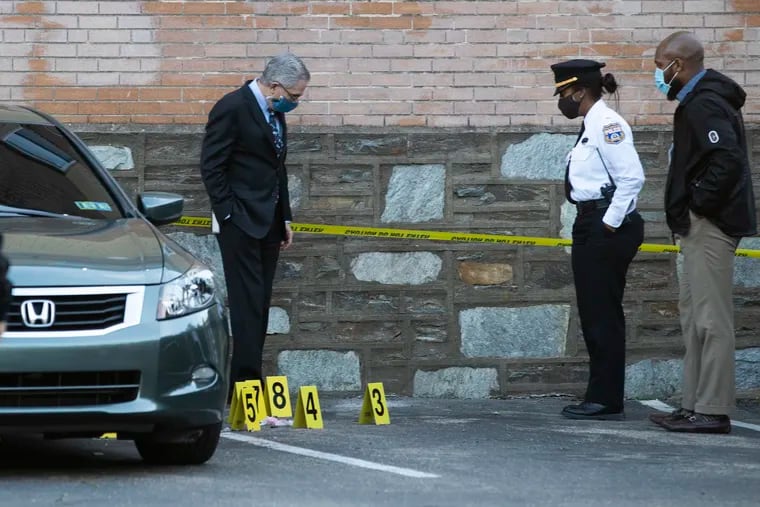 Philadelphia District Attorney Larry Krasner, left, and police at the scene where 4 people were shot, one fatally near 75th and Woodcrest St. on March 11, 2021.