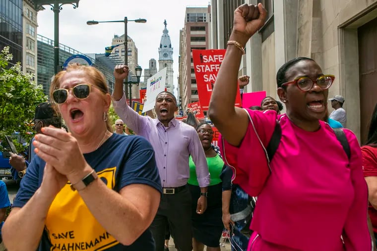 Nicolas O'Rourke (back left) and Kendra Brooks (back right) march with Hahnemann University Hospital workers to save it from closure in July. O'Rourke and Brooks are being backed by five service worker unions in City Council's at-large race.