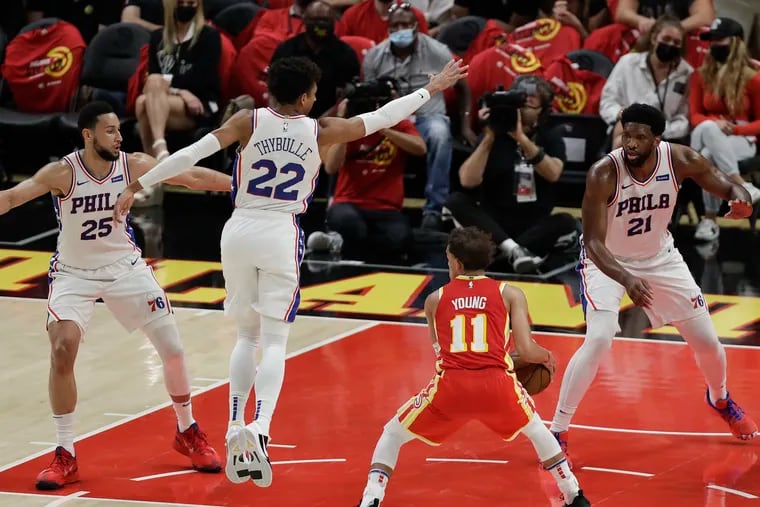 Sixers guard Ben Simmons, guard Matisse Thybulle and center Joel Embiid surround Atlanta Hawks guard Trae Young in Game 3 of the NBA Eastern Conference playoff semifinals on Friday, June 11, 2021 in Atlanta.