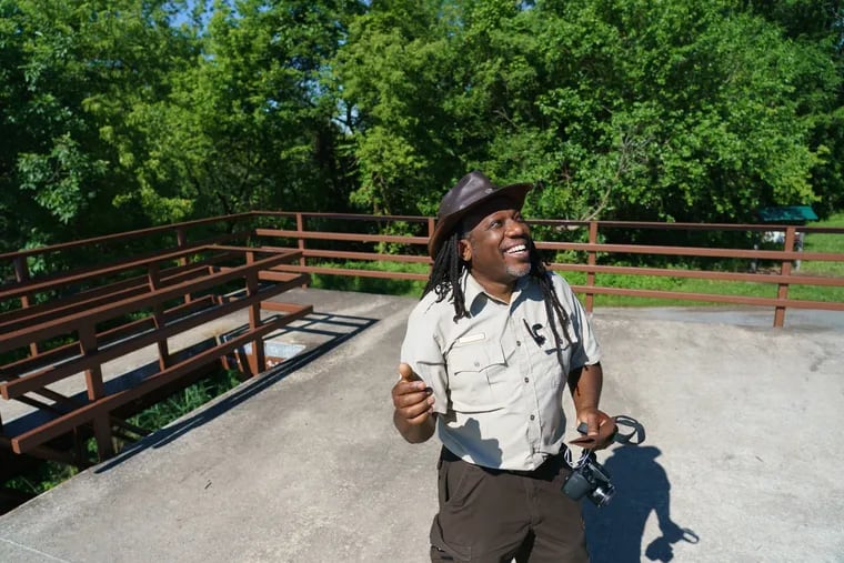 Lamar Gore, manager of the John Heinz National Wildlife Refuge, listens to birds sing.