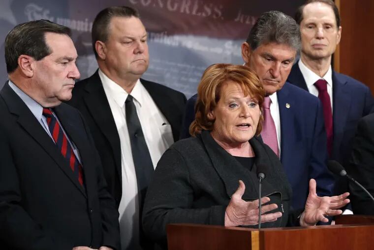 Sen. Heidi Heitkamp (D., N.D.) is joined by colleagues (from left)  Joe Donnelly (D., Ind.), Jon Tester (D., Mont.),  Joe Manchin (D., W.Va.), and Ron Wyden (D., Ore.) on Nov. 28 to discuss their hopes for a bipartisan approach to tax reform.