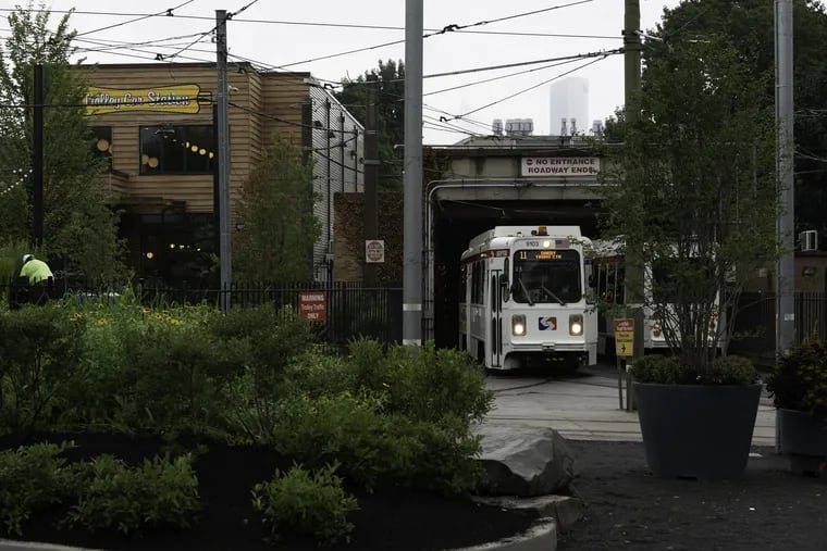 Septa trollies emerging from the 40th Street portal into the new landscaped garden. A new cafe helps animate the space.