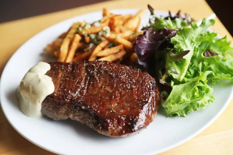 Creekstone prime New York strip with herb frites and salad at Cerise Craft Steakhouse.