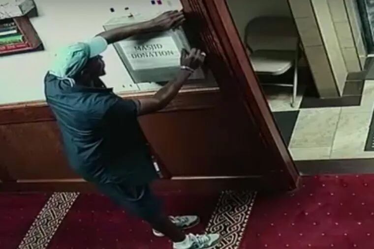 Screenshot from a video released by police of a man who twice robbed the same Northeast Philadelphia mosque and made his escape on a bicycle.