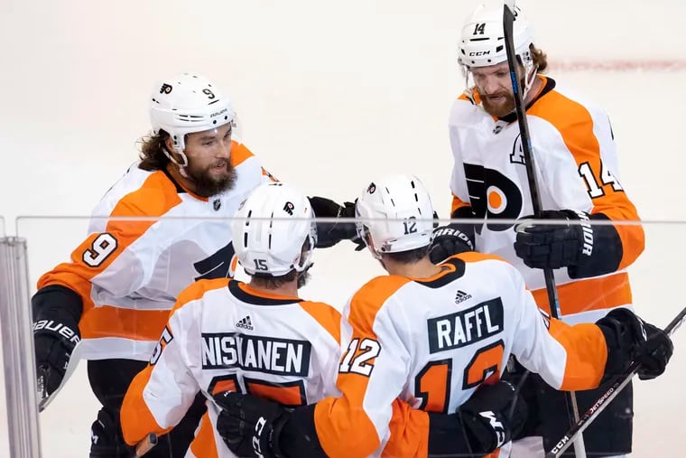 Philadelphia Flyers left wing Michael Raffl (12) is congratulated by teammates defenceman Ivan Provorov (9), defenceman Matt Niskanen (15) and centre Sean Couturier (14) after scoring on the Montreal Canadiens.